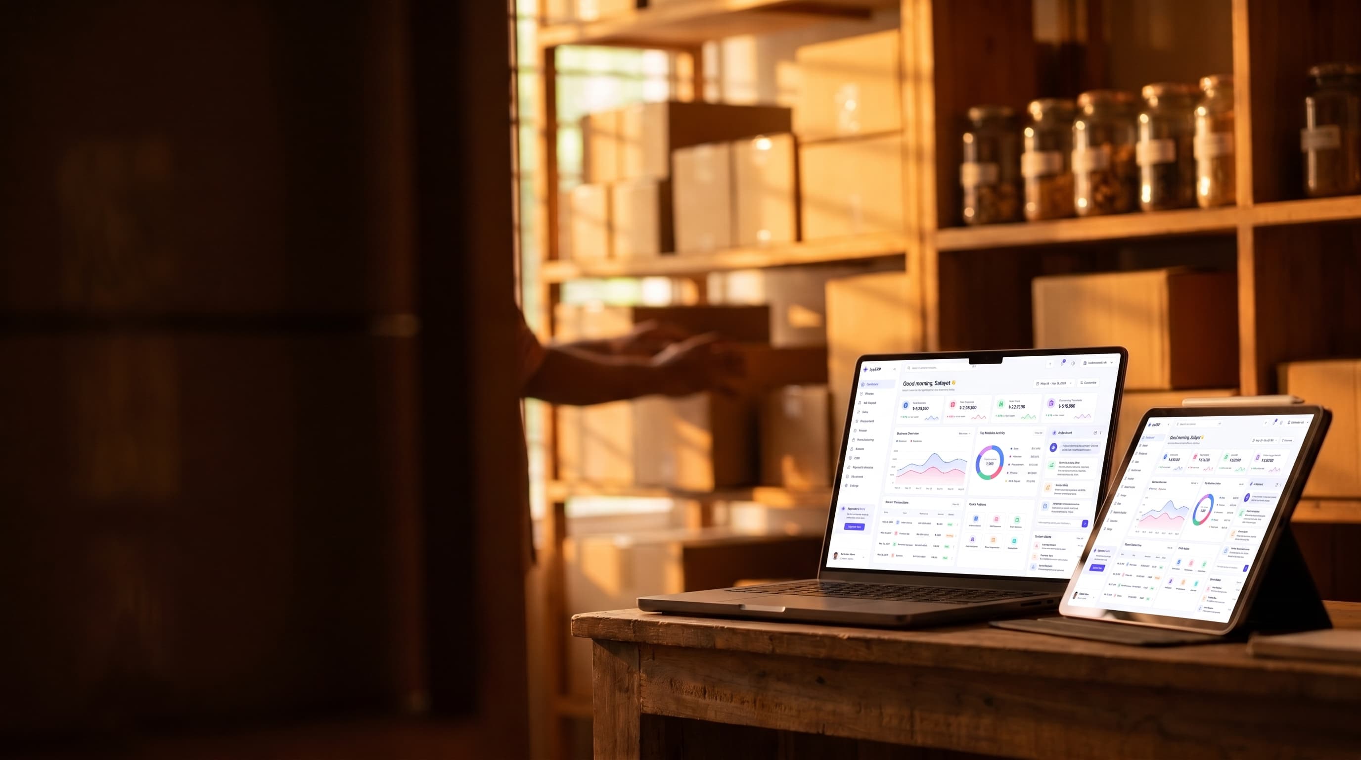 Buzzy dashboard on a laptop and tablet in a warm small-business stockroom